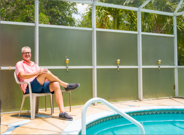 Don Hopkins, IncredibleBank mortgage customer, sitting in a chair by his pool.